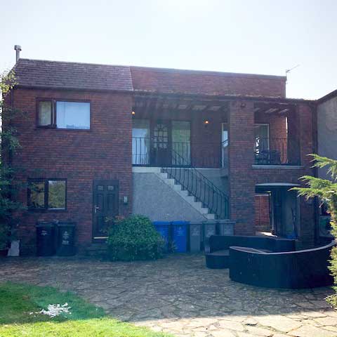 Conversion of existing outbuilding into self-contained dwelling following initial refusal